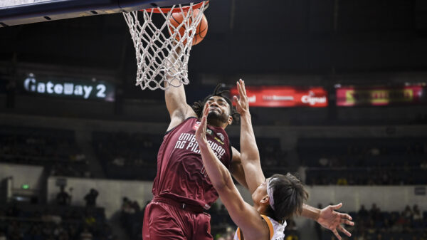 Francis Lopez brings the ball to the rim in UP's win over UST