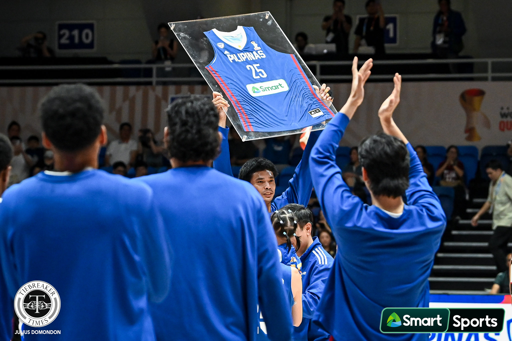 Japeth Aguilar lifts a framed jersey at a retirement tribute with Gilas Pilipinas ahead of their game against Guam, at the Blue Eagle Gym